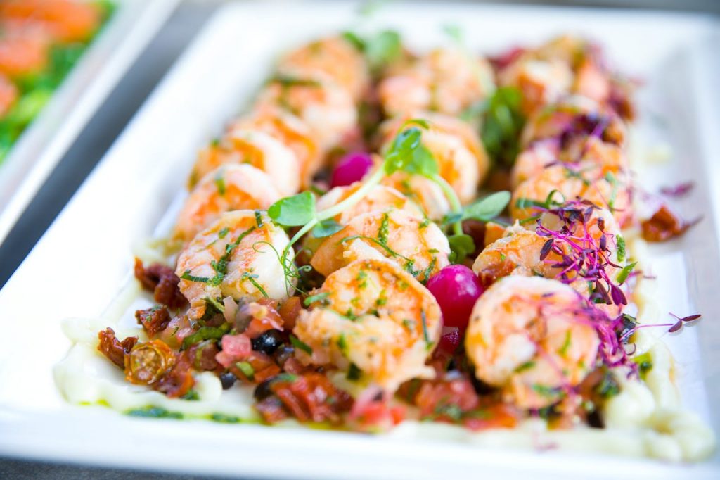 pexels-photo-3843224-1 Closeup of delicious shrimps with vegetables and microgreens on white plate on catering table
